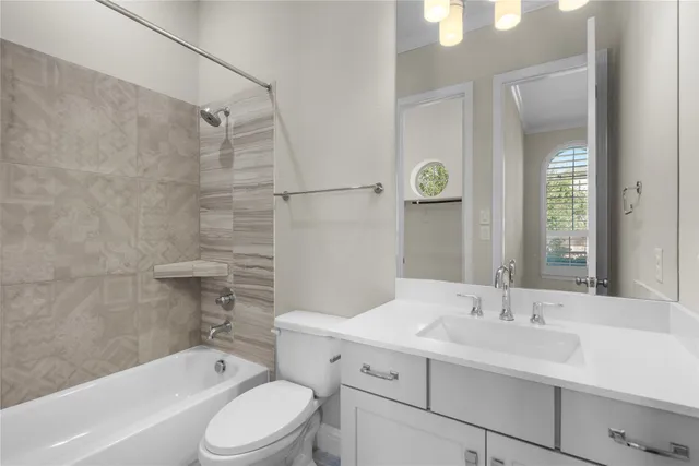 a bathroom with a sink toilet vanity and shower