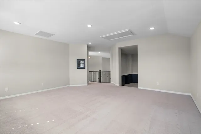 an empty room with windows and a fireplace