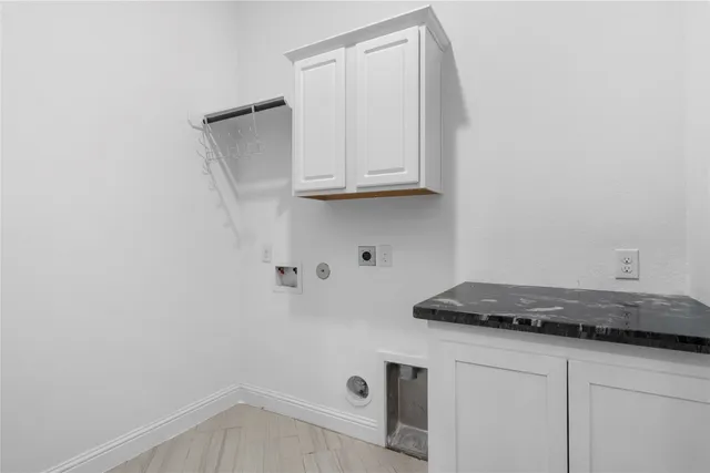 a kitchen with a white cabinets and a stove