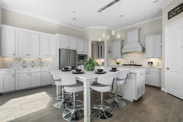 a kitchen with white cabinets and stainless steel appliances