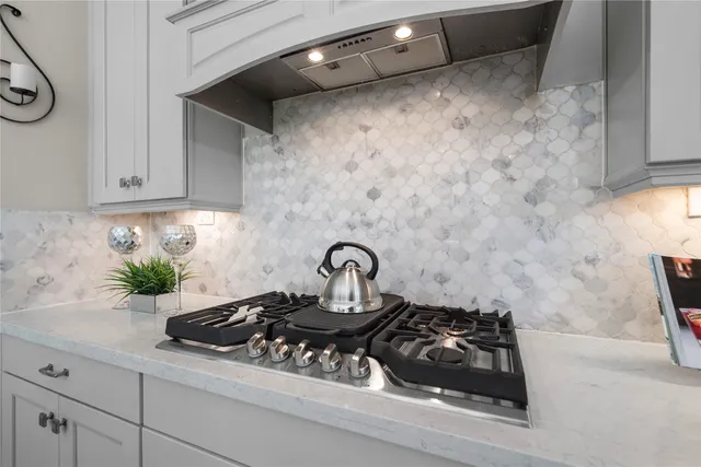 a kitchen with a stove and cabinets