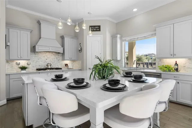 a kitchen with a table and chairs in it