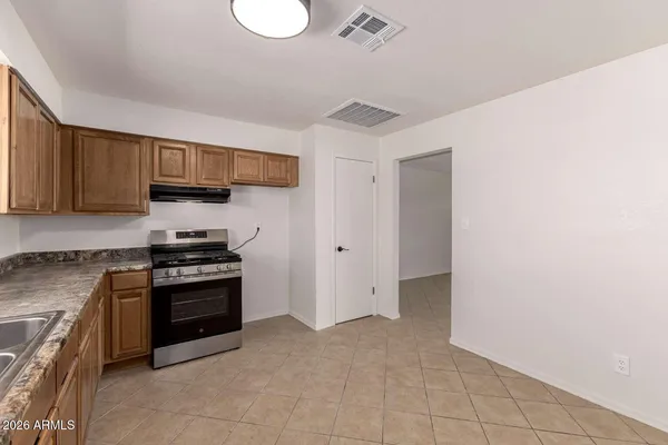 a kitchen with stainless steel appliances granite countertop a stove and a sink