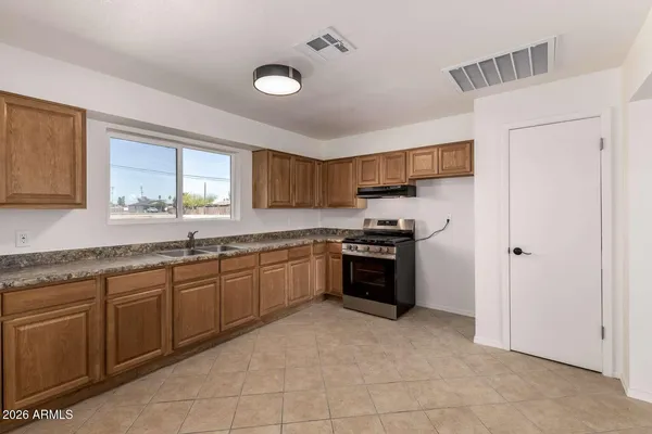 a kitchen with stainless steel appliances granite countertop a stove top oven a sink and dishwasher