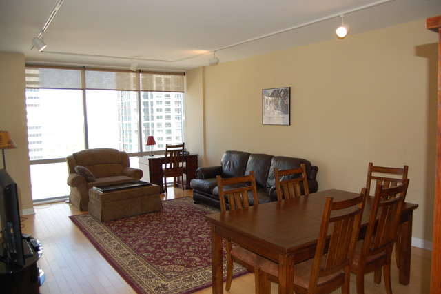 8 East Randolph Street, Unit 1803 Chicago, IL 60601 - Photo 4 of 16 a living room with furniture and a flat screen tv