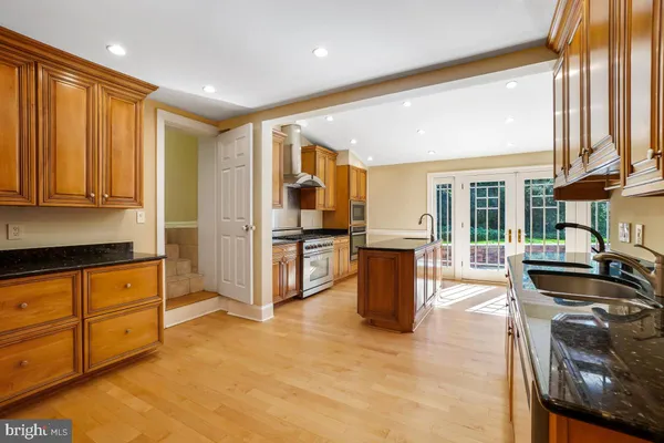 a open kitchen with granite countertop sink and cabinets