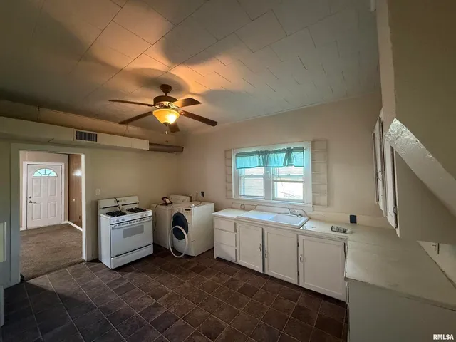 a kitchen that has a sink and a stove