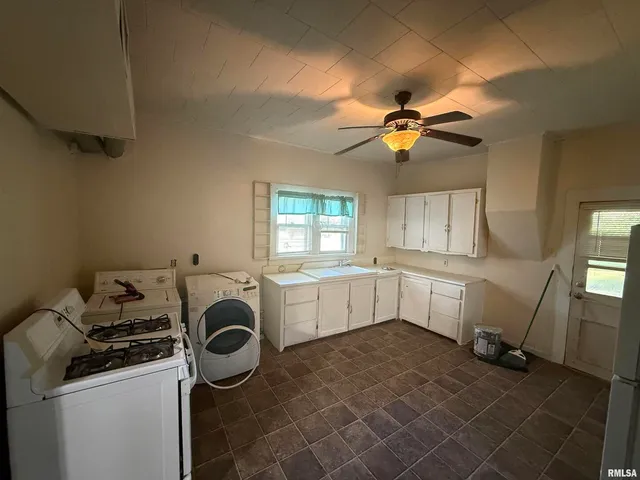 a kitchen with a stove a sink and a refrigerator