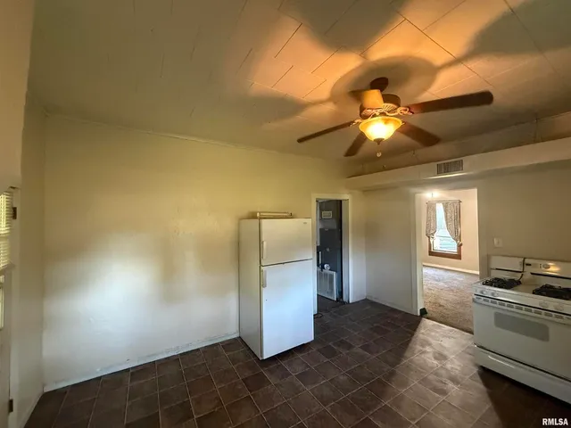 a kitchen with stainless steel appliances a refrigerator and a stove