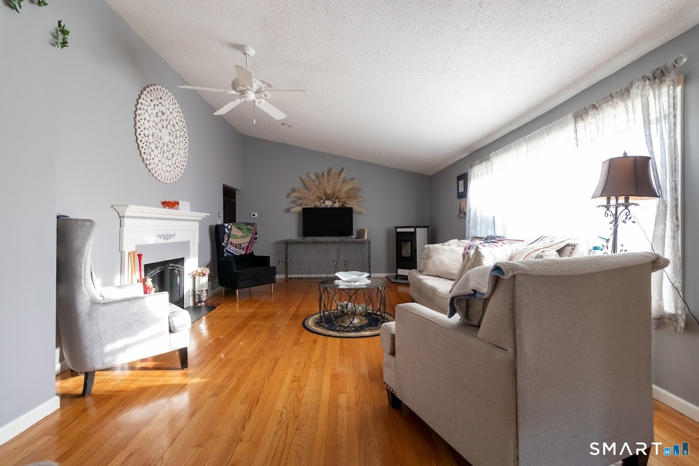 763 North Street Suffield, CT 06078 - Photo 20 of 40 a living room with furniture a fireplace and a large window