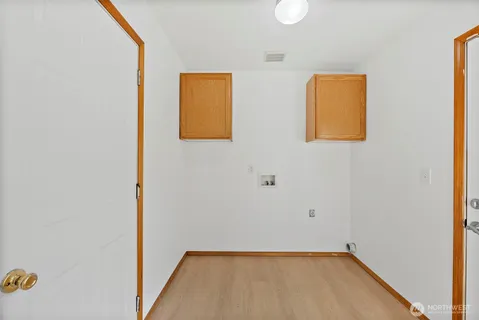 a view of a room with rack on the wall and a window