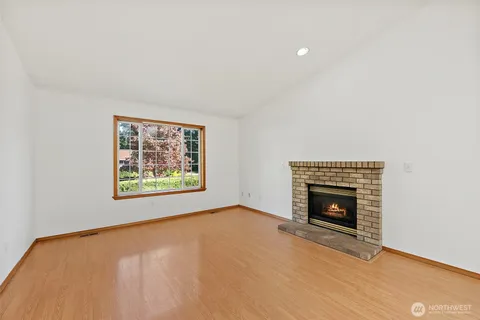 a view of empty room with a fireplace