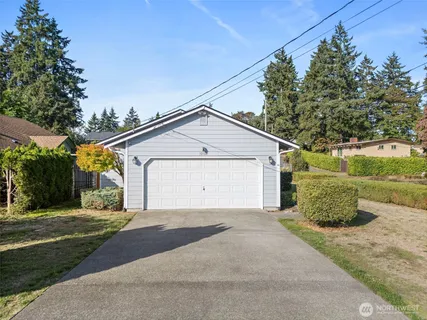 a view of a house with a yard and garage