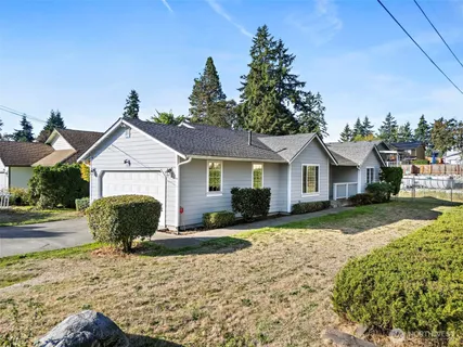 a view of a white house with a yard