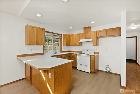 a kitchen with a sink a stove and cabinets