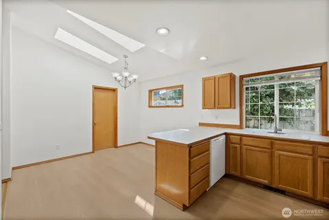 a kitchen that has a sink and a stove in it