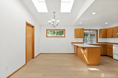 a view of kitchen with granite countertop cabinets and wooden floor