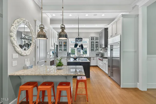 a living room with furniture and a view of kitchen