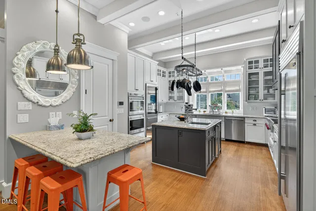 a living room with furniture large windows and a fireplace