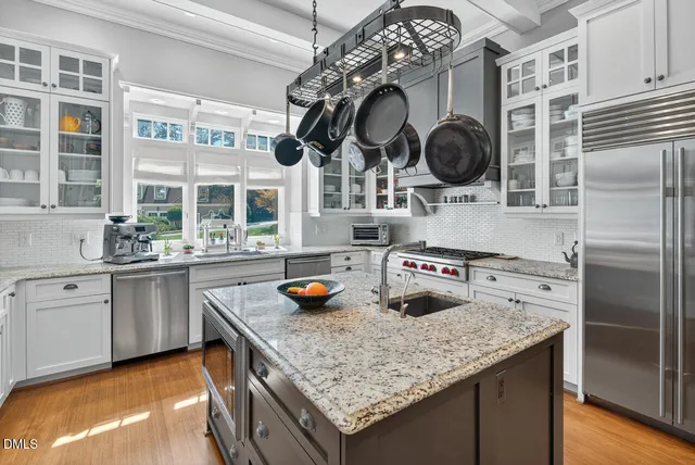 a bedroom with a bed chandelier and window