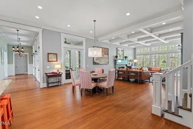 a living room with furniture a chandelier furniture and a window