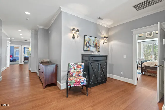 a bedroom with a large bed chandelier and a window