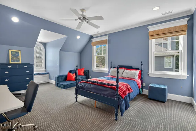 a backyard of a house with fountain table and chairs