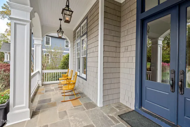 a dining room with furniture a chandelier and wooden floor
