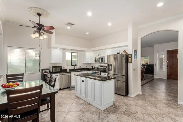 a kitchen with refrigerator a stove and a sink
