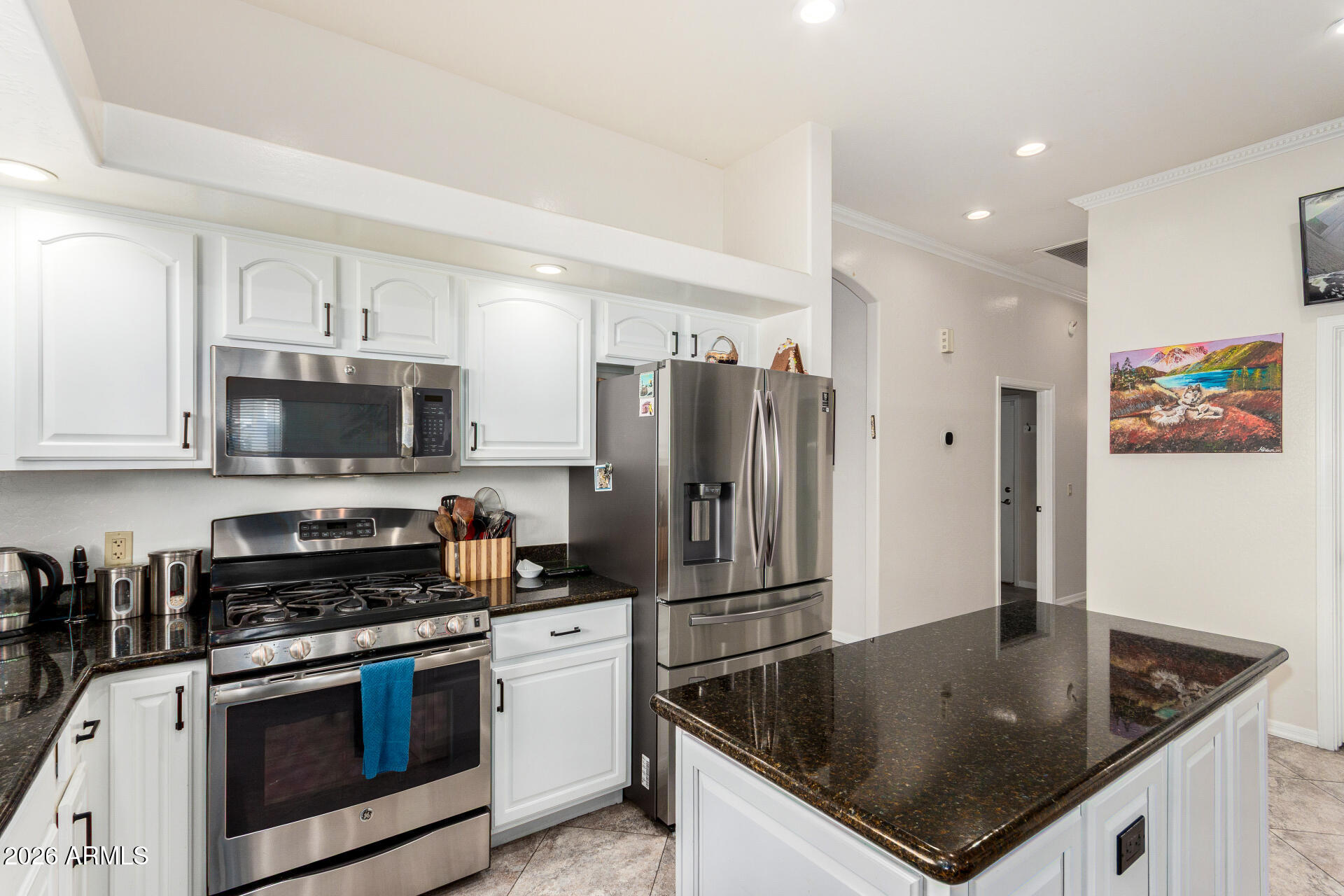 8912 North 15th Lane Phoenix, AZ 85021 - Photo 13 of 36 a kitchen with stainless steel appliances granite countertop a sink a stove and a refrigerator