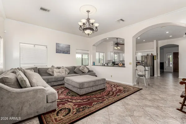 a living room with furniture and a chandelier