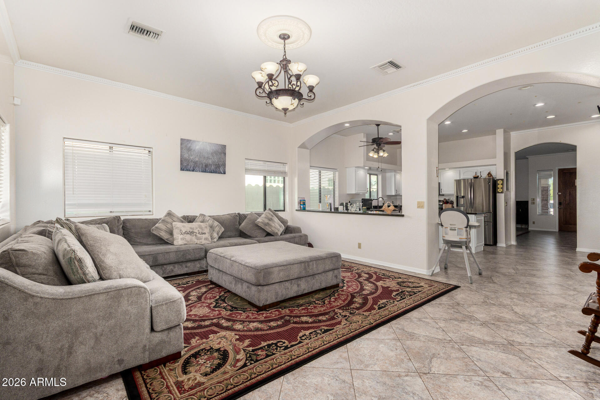 8912 North 15th Lane Phoenix, AZ 85021 - Photo 16 of 36 a living room with furniture and a chandelier