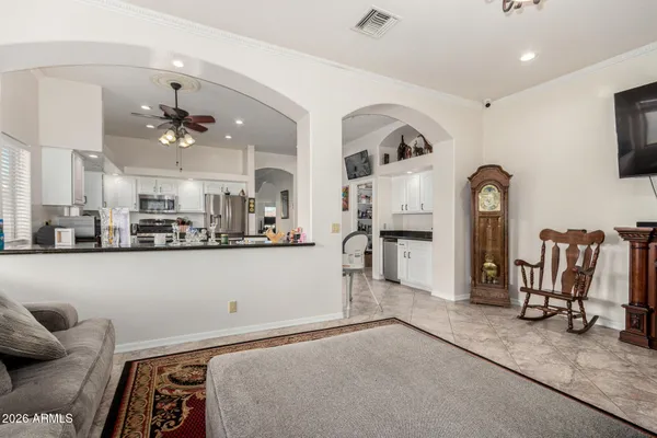a living room with furniture a flat screen tv and white walls