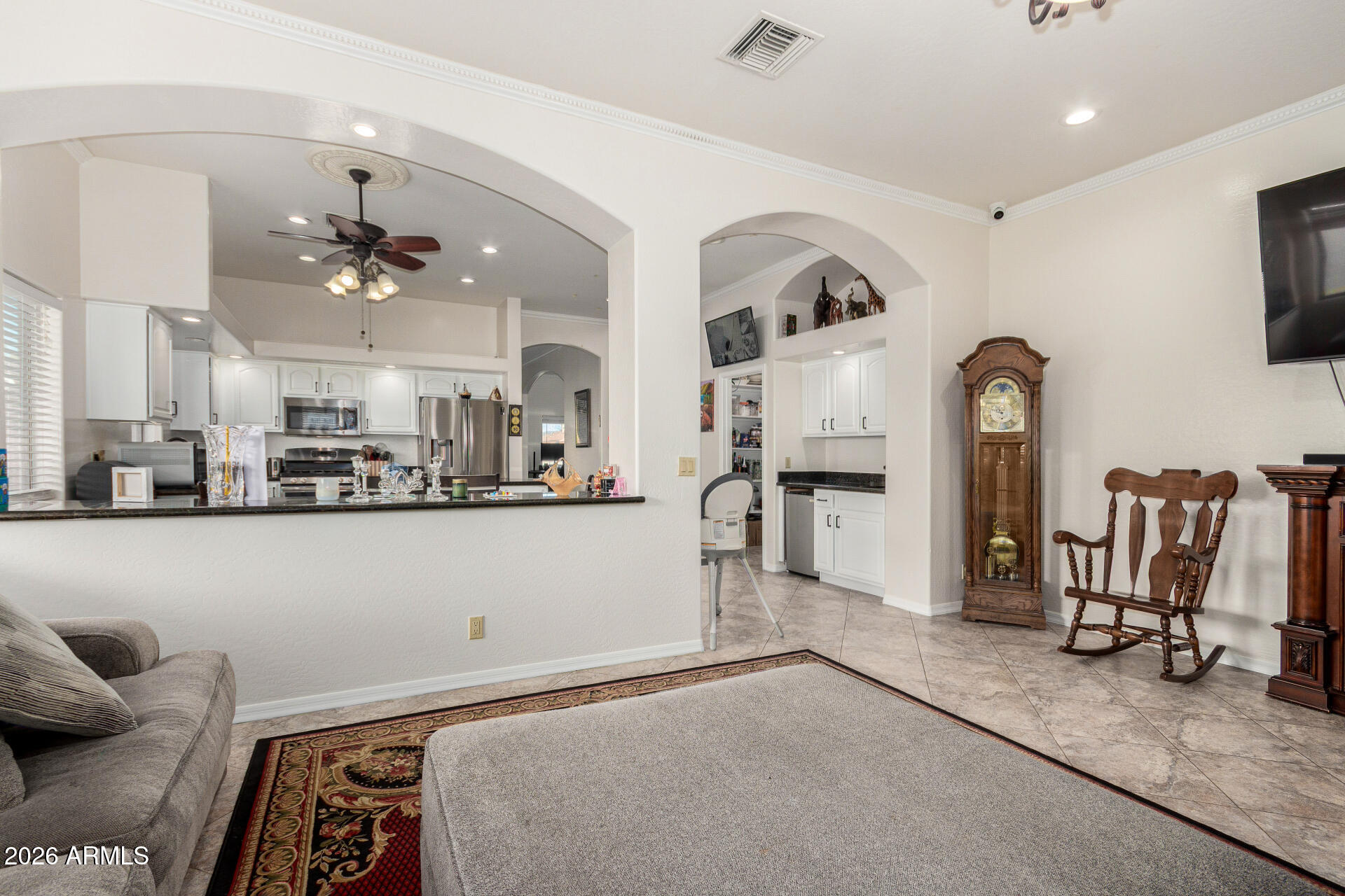 8912 North 15th Lane Phoenix, AZ 85021 - Photo 17 of 36 a living room with furniture a flat screen tv and white walls
