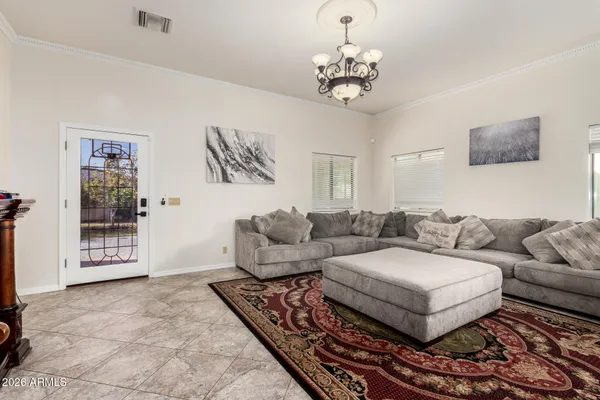 a living room with furniture and a chandelier