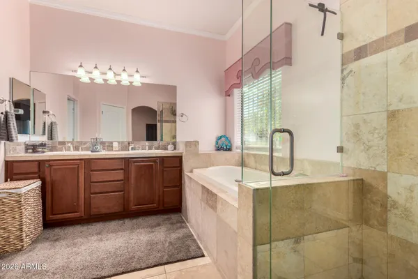 a spacious bathroom with a sink a vanity a mirror and bathtub