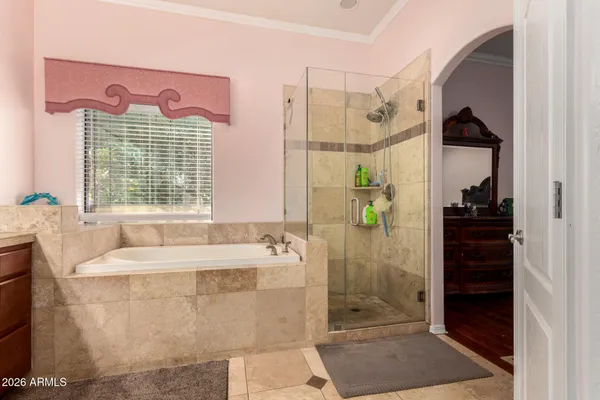 a bathroom with a bathtub sink and mirror