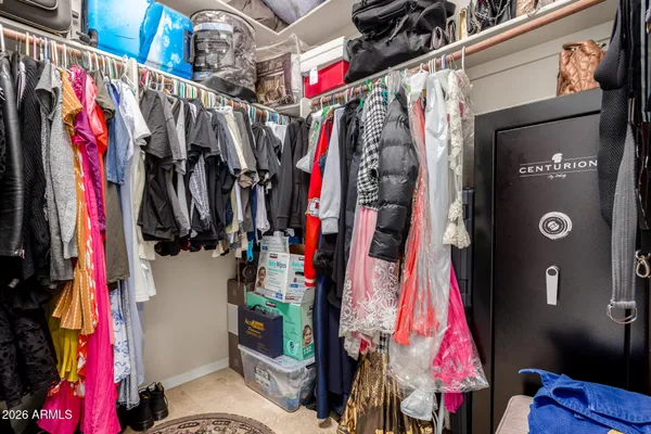 a view of walk in closet with clothes