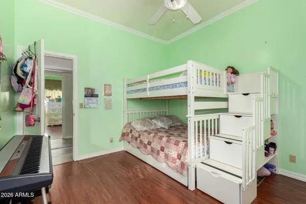 a bedroom with bunk bed and a window