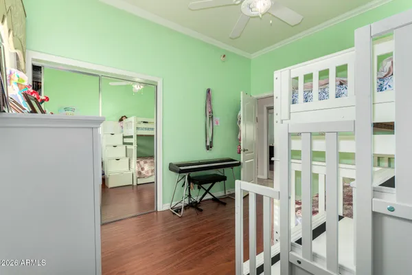 a view of a room with lots of wooden furniture and a window