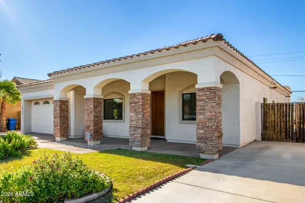 a view of a house with large windows and yard