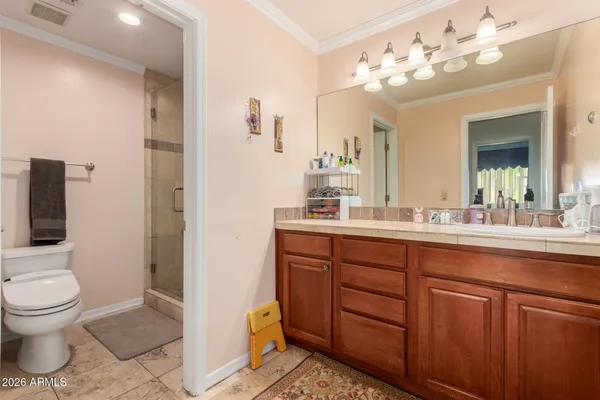 a spacious bathroom with a toilet sink and mirror