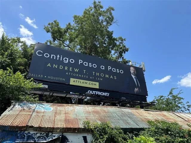 a sign board with a play ground in the back