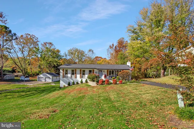 a front view of a house with a yard table and chairs