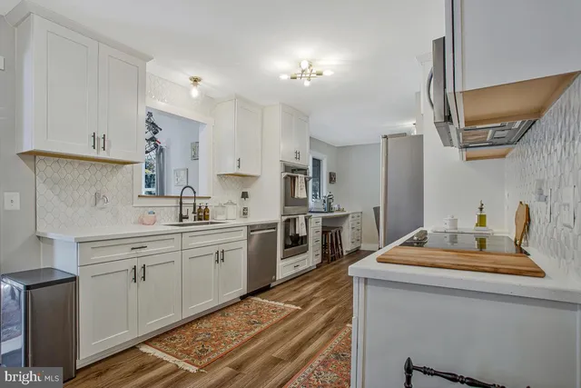 a kitchen with a sink stove and refrigerator
