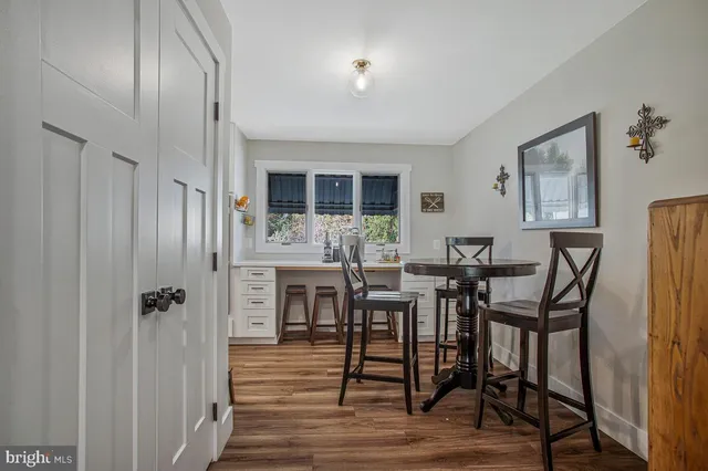 a view of a dining room with furniture and window