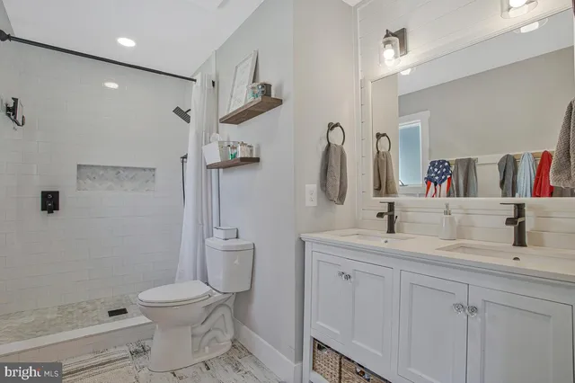 a bathroom with a toilet sink and shower