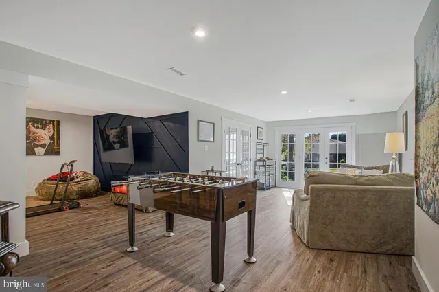 a living room with furniture a piano and a flat screen tv