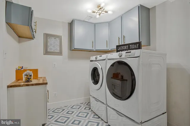 a utility room with sink dryer and washer