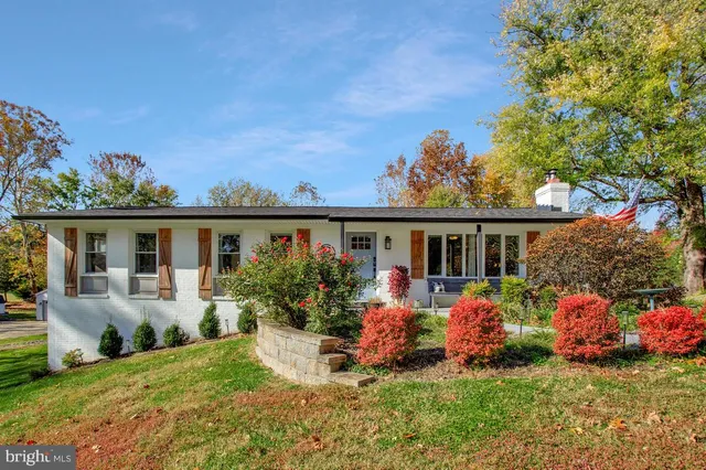 a front view of a house with a yard table and chairs